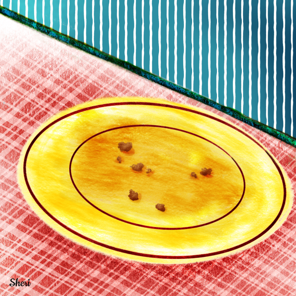 yellow plate with cookie crumbs on red plaid counter in front of teal striped walls