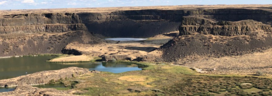 Dry Falls where 200 ft basalt lava flows tower of small lakes
