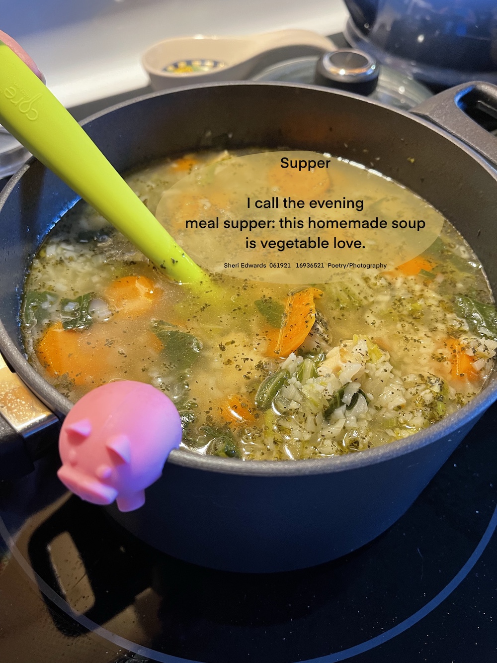 a pot on the stove of vegetable soup with carrots, cauliflower rice, bok choy with leaves, and celery. A pink pig lid holder and a lime green spoon rest on the pot.