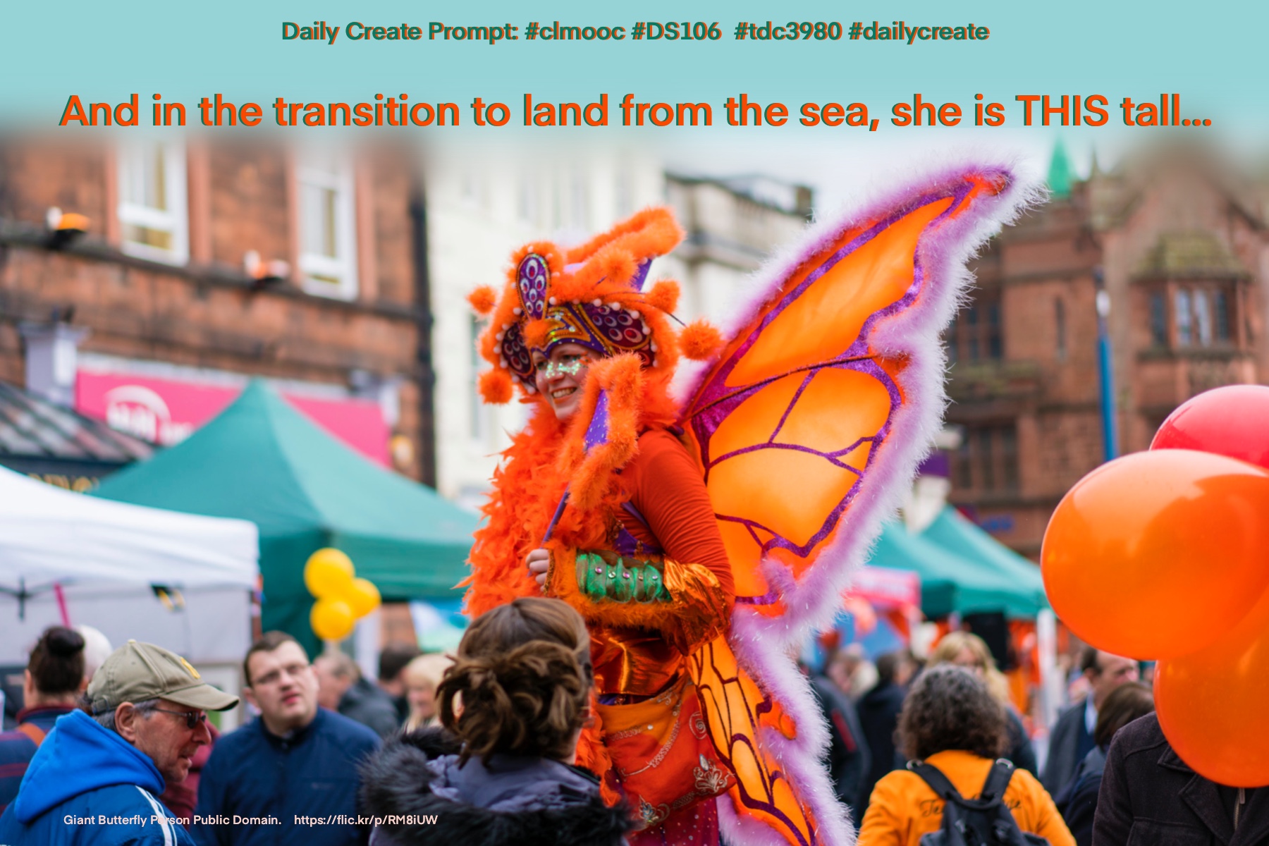 Festive woman dressed as orange butterfly towers above the crowd in the streets