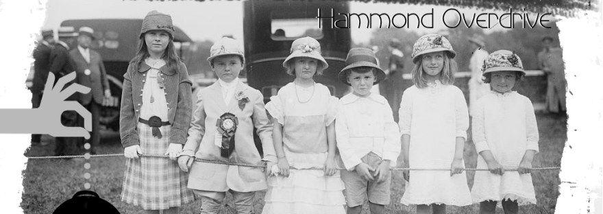 Old 1900s picture of kids in a line outside behind a rope looking forward As an album cover for a fake band Hammond Overdrive’s Anticipation [Revival]