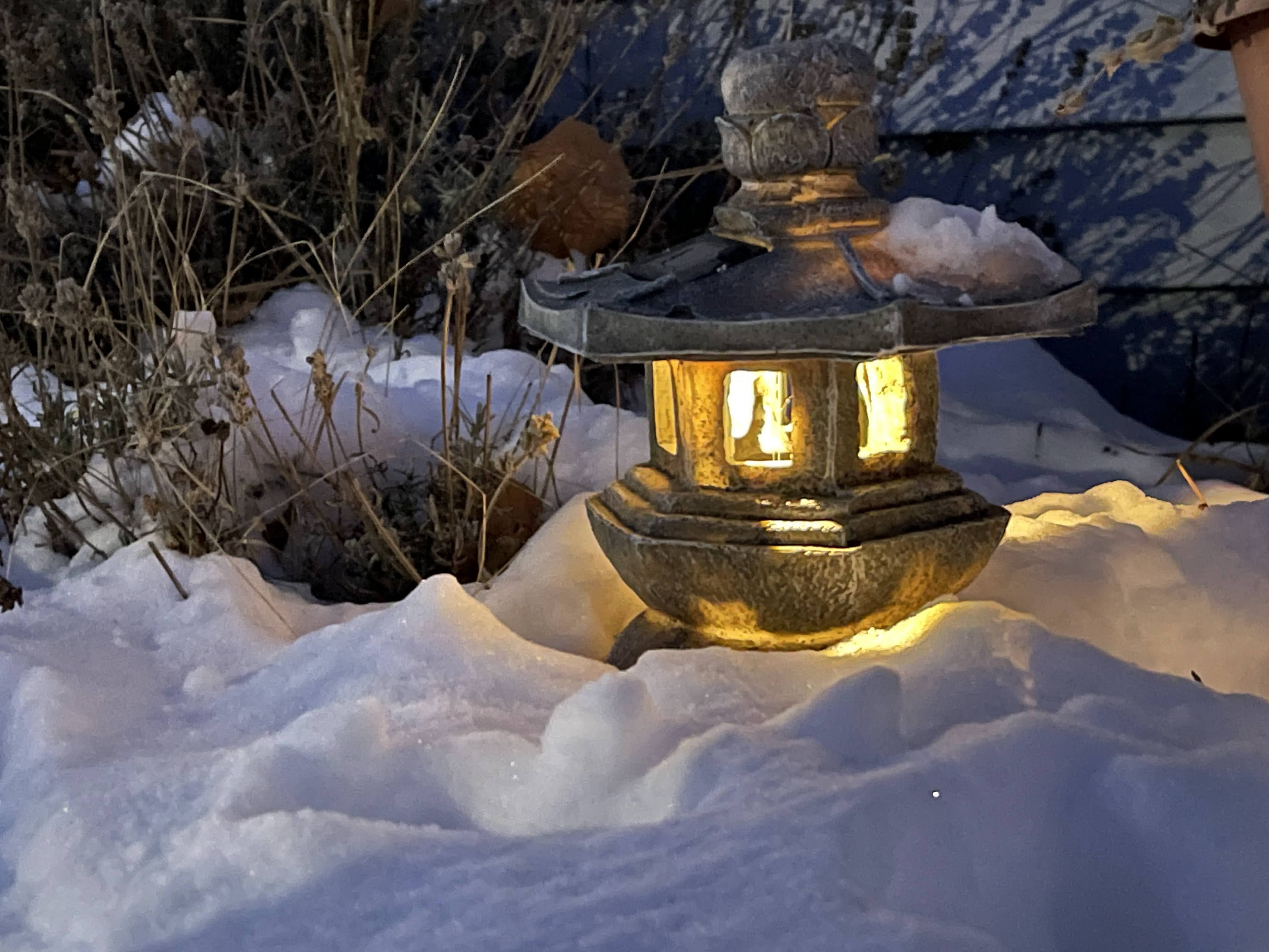 An Ishidoro lantern glowing in the snow