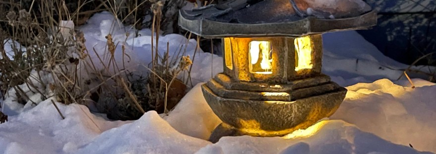 An Ishidoro lantern glowing in the snow