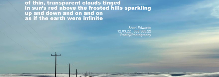 hilly countryside and road covered in snow with a red tint to thin clouds