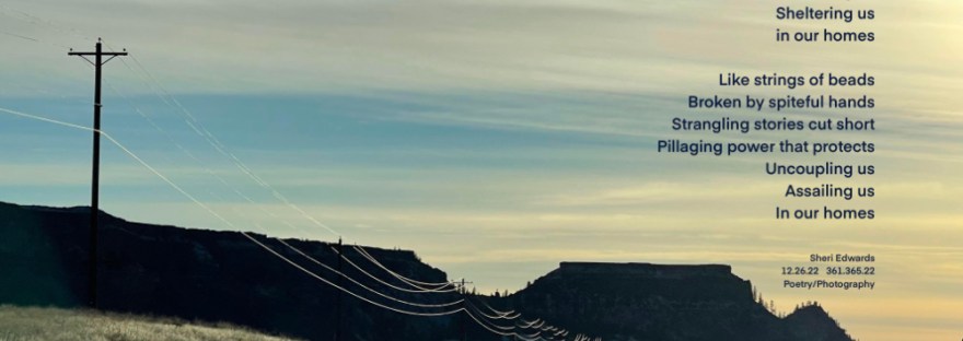 Frosty, winter day with ice on the wires looping along the highway beneath streaming clouds in the blue sky