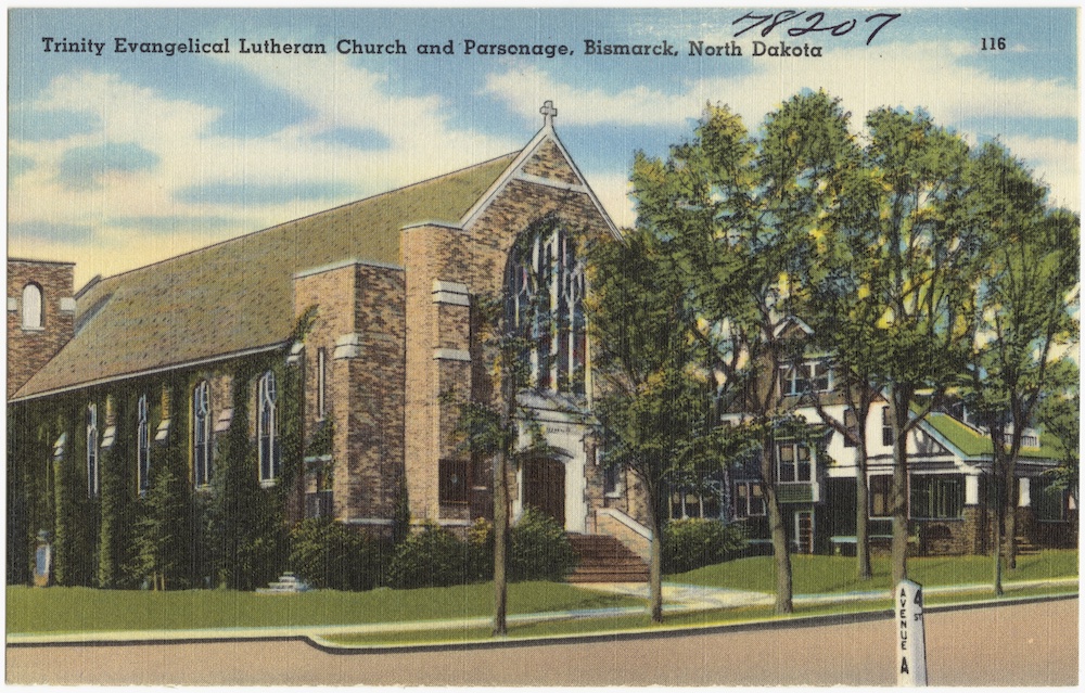 Lovely Anglican style brick Lutheran church on a treed street next to the tutor-style parsonage