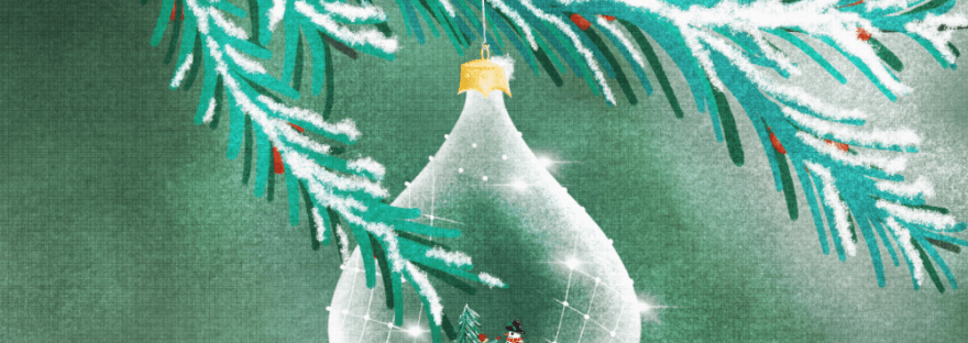 A frosty glass ornament with a boy building snowman hangs from a pine tree with red berries