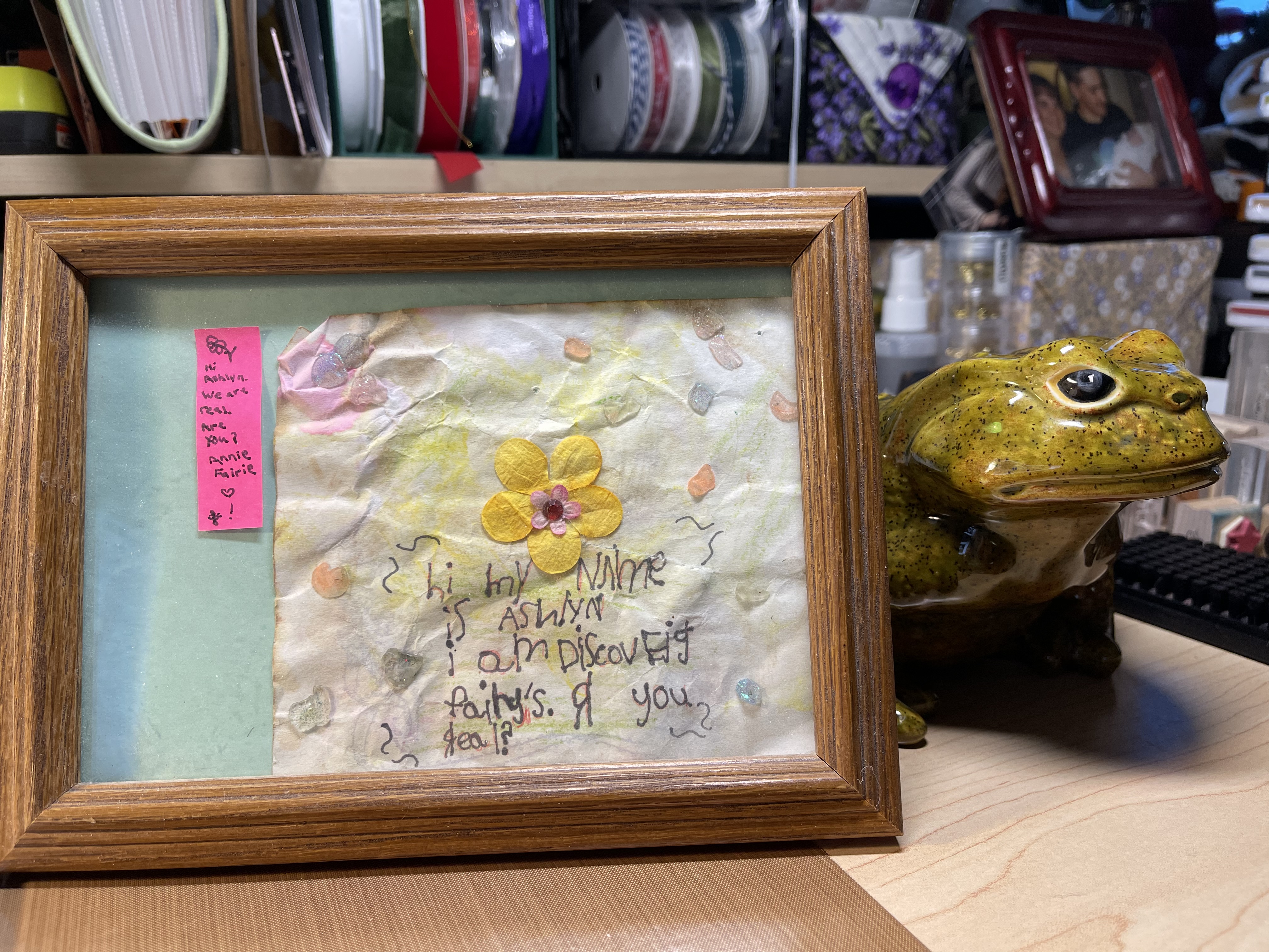 A framed note to fairies from our granddaughter: Hi. My name is Ashlyn. I am discoveig fairy's. R you real?