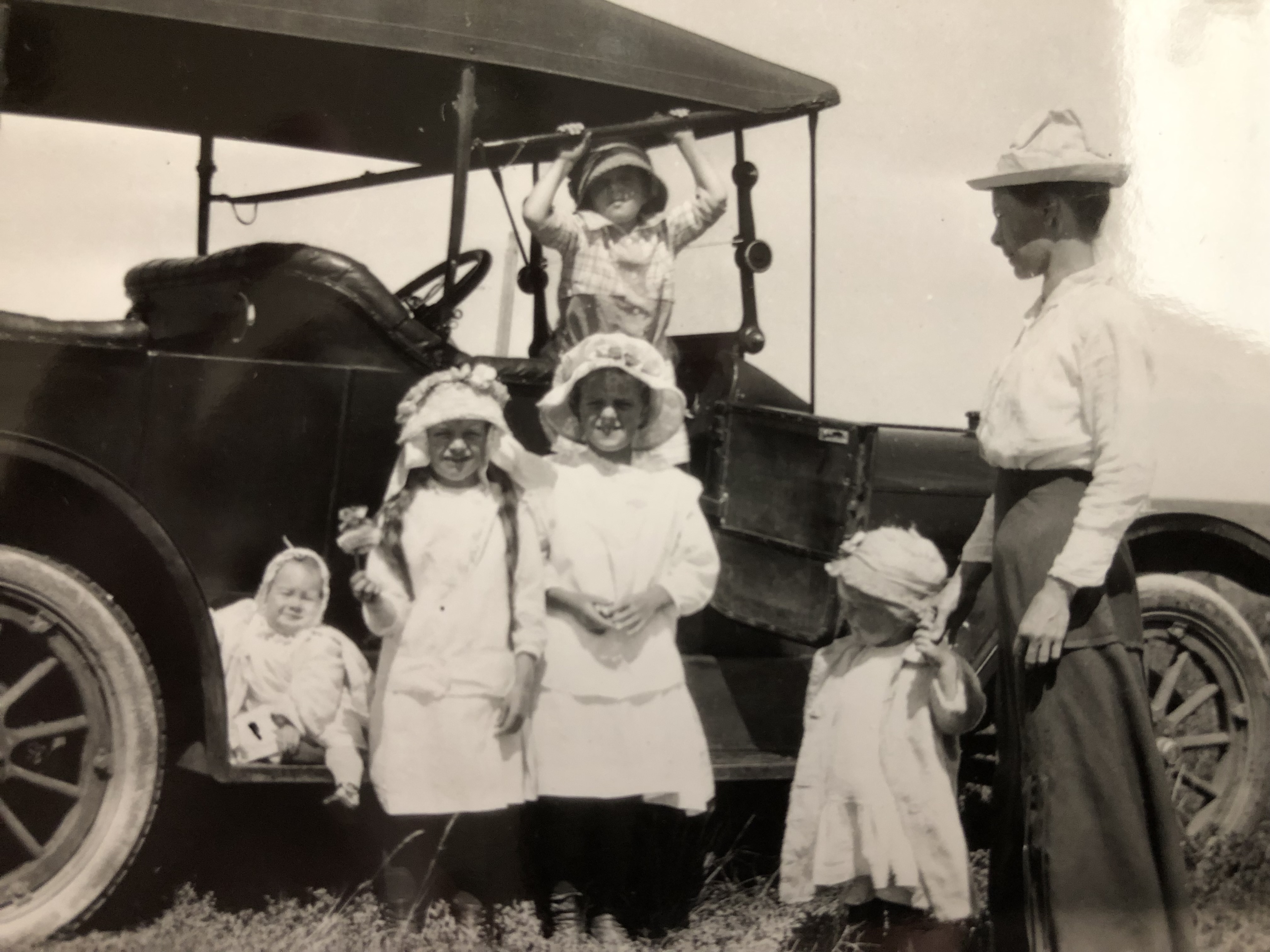 Gramma Sophie, my dad hanging, aunties and Uncle Dee as baby In Sunday dress up on the horseless carriage ©