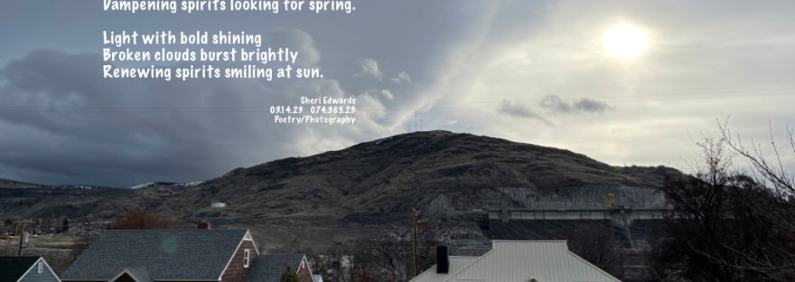 Dark skies broken by a burst of sunlight through the grey