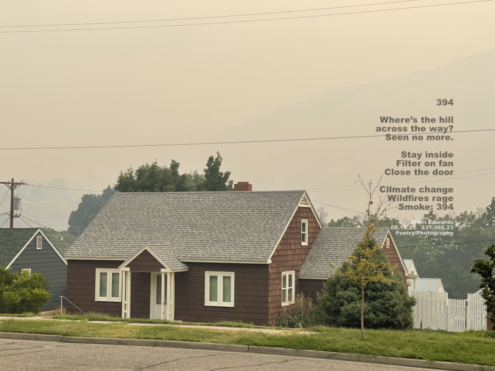 Across the street, through our window-- smoke-filled sky from Canadian wildfires block the hillside view across the river