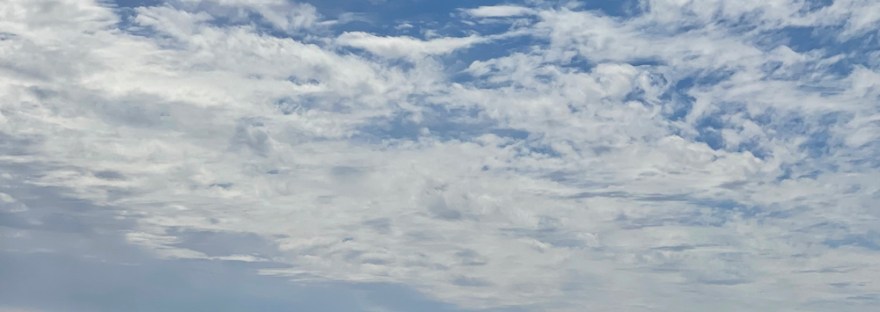 a dragon cloud in the sky chasing the clouds away