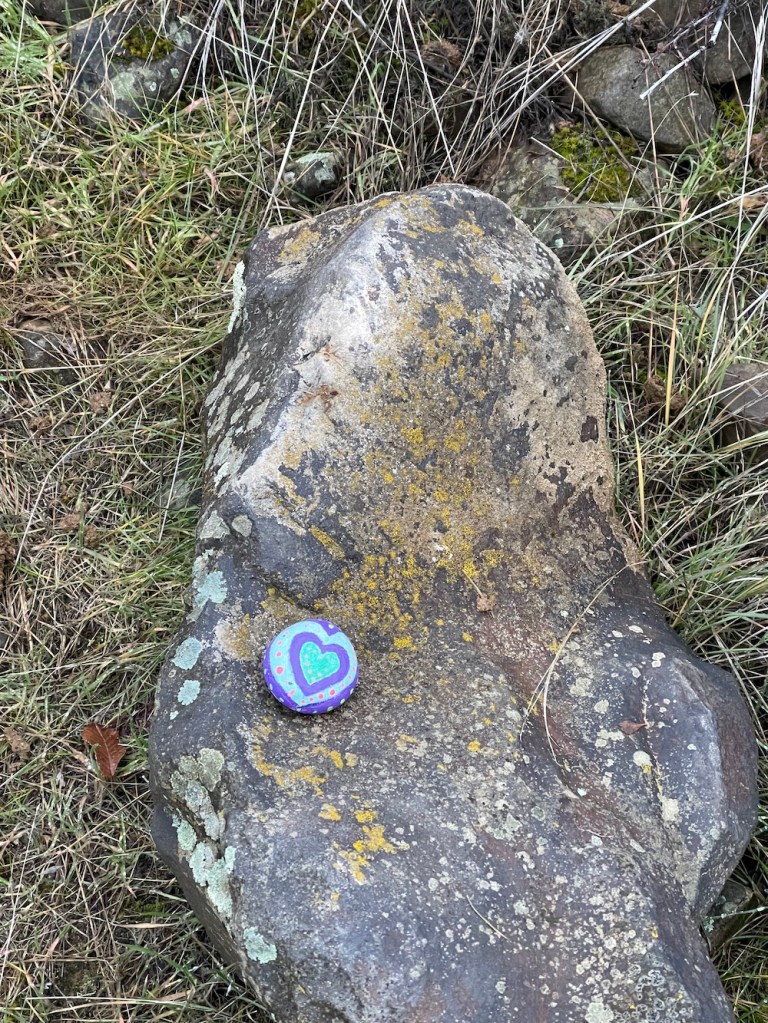 found the same painted rock, again -- concentric hearts with dots around it-- on another path