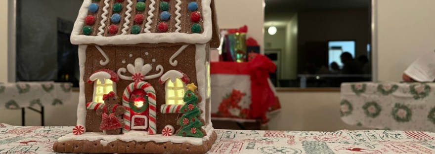 Holiday gingerbread house on table ready for a holiday gathering