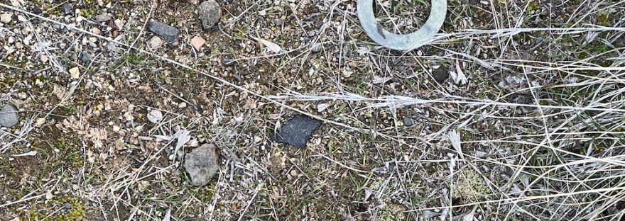 a circle of something on the ground, fallen off a vehicle, no doubt