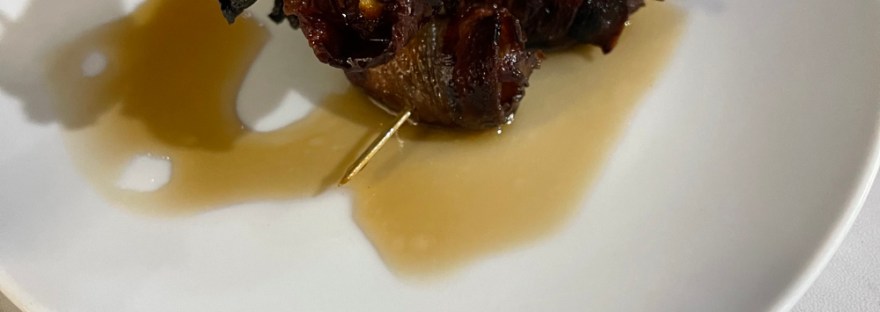 bacon wrapped dates layered like a sculpture