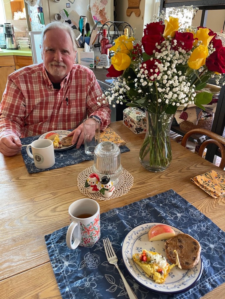 Scott at the table with bouquet