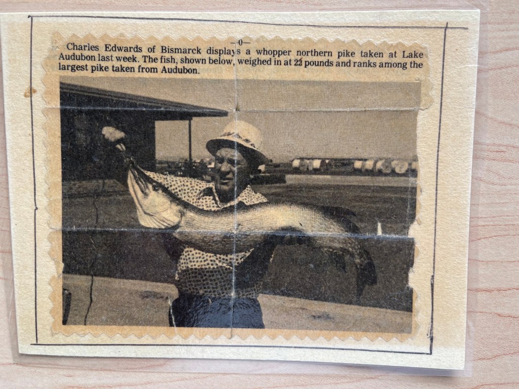 newspaper clipping of my dad Charles Edwards holding his whopper northern pike; 22 pounds