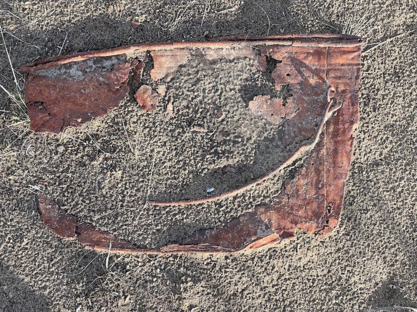 Weird. I found a smile in the sand, but it was just a flattened, rusted old can. Poetry by Sheri Edwards